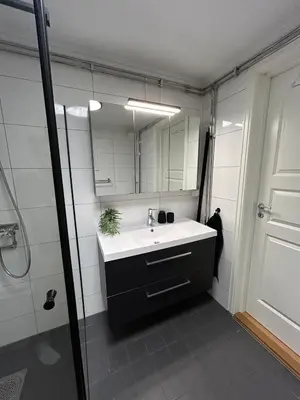 a bathroom with a sink and a mirror at Sjusjøstua by Norgesbooking - cabin close to cross country trails in Ringsaker