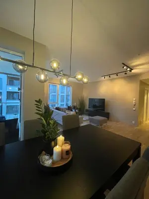 a living room with a table with candles on it at Splitter ny, romslig leilighet sentralt på Nyhavna leies ut in Trondheim