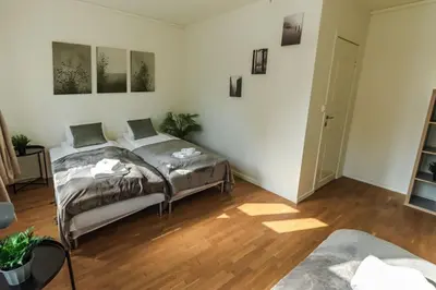a bedroom with a bed and a wooden floor at Stylish place in the heart of Bergen in Bergen