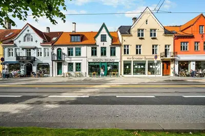 an empty street in a town with buildings at Stylish place in the heart of Bergen in Bergen