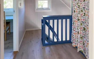a staircase with a blue rail in a room at 3 Bedroom Stunning Home In Fiksdal in Fiksdal