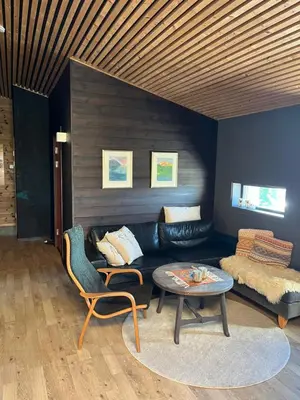 a living room with a couch and a table at Moderne hytte Sjusjøen in Sjusjøen