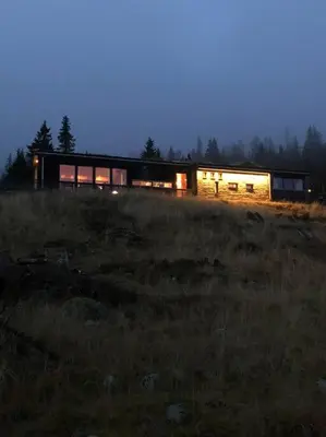a house on a hill in a field at night at Moderne hytte Sjusjøen in Sjusjøen