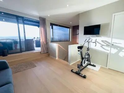 a living room with a exercise bike and a tv at Ski VM 2025 Eksklusivt hus in Trondheim