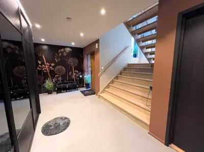 a hallway of a house with stairs and a stair mat at Ski VM 2025 Eksklusivt hus in Trondheim