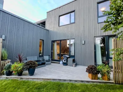 a house with a patio with plants in front of it at Ski VM 2025 Eksklusivt hus in Trondheim