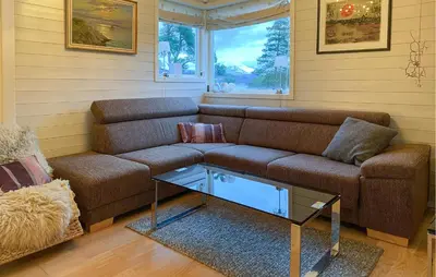 a living room with a couch and a coffee table at Beautiful Home In Skodje in Vatne