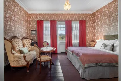 a bedroom with a bed and a table and chairs at Jervell 3 Bnb in Ålesund