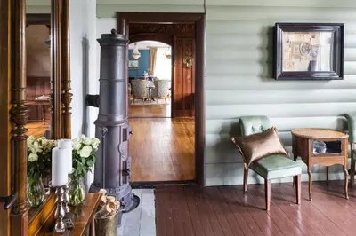 a hallway of a home with a chair and a table at Jervell 3 Bnb in Ålesund