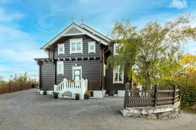 a house with a wooden fence in front of it at Jervell 3 Bnb in Ålesund