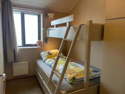 a bunk bed with a ladder in a room at Perfect Family Base In Beitostølen in Beitostøl