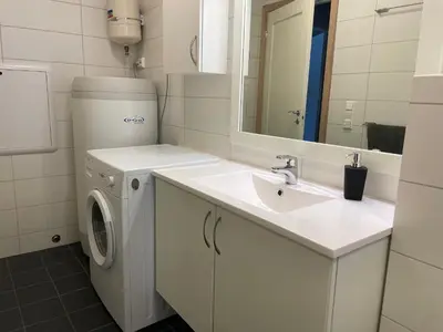 a white bathroom with a sink and a washing machine at Perfect Family Base In Beitostølen in Beitostøl