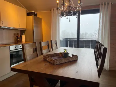 a kitchen with a wooden table and a dining room at Perfect Family Base In Beitostølen in Beitostøl