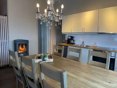 a kitchen with a dining table and a fireplace at Perfect Family Base In Beitostølen in Beitostøl