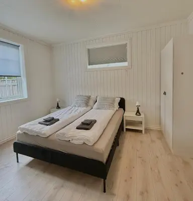 a bedroom with a bed with two towels on it at Sentral og koselig leilighet! in Lillehammer
