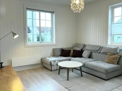 a living room with a couch and a table at Sentral og koselig leilighet! in Lillehammer