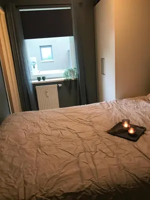 a tray with candles on a bed with a window at Ski VM i Trondheim 2025 in Trondheim