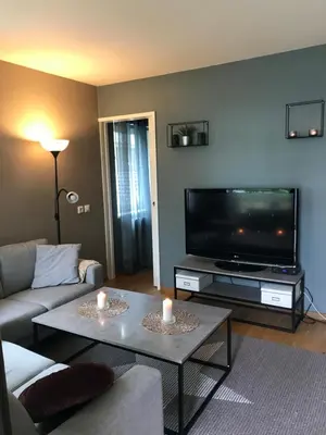 a living room with a couch and a flat screen tv at Ski VM i Trondheim 2025 in Trondheim