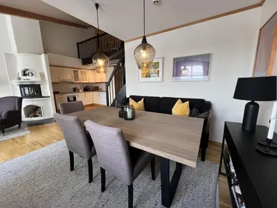 a dining room with a table and a couch at Stylish And Spacious Apartment In The Heart Of Beitostølen in Beitostøl