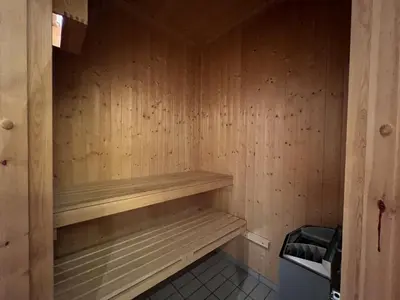a sauna with wooden walls and wooden shelves at Stylish And Spacious Apartment In The Heart Of Beitostølen in Beitostøl