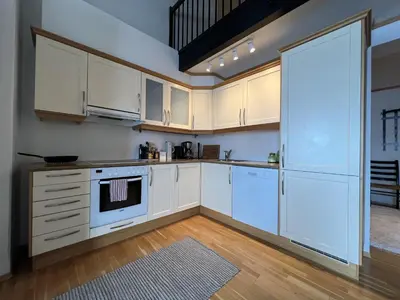 a kitchen with white cabinets and a stove at Stylish And Spacious Apartment In The Heart Of Beitostølen in Beitostøl