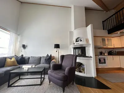 a living room with a couch and a fireplace at Stylish And Spacious Apartment In The Heart Of Beitostølen in Beitostøl