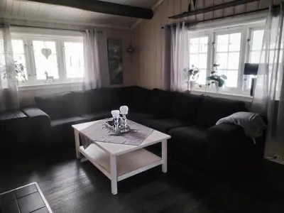 a living room with a couch and a coffee table at Hessdalen hytte in Vårhus