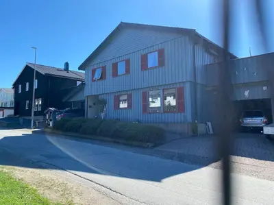 a house with a car parked in front of it at Cozy apartment near city center and nature in Kristiansund