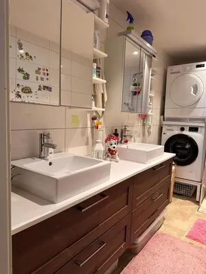 a bathroom with two sinks and a washing machine at Bergen peaceful loft in Bergen