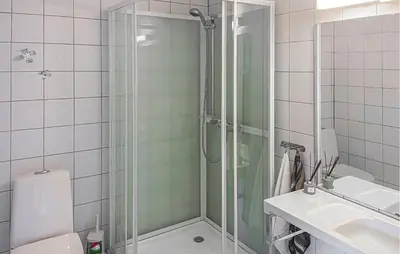 a bathroom with a shower and a toilet and a sink at Lovely Apartment In Bjorli With Sauna in Bjorli