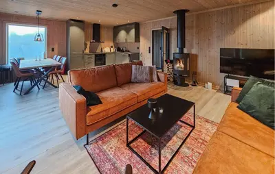 a living room with a couch and a table at Awesome Home In Rauland in Rauland