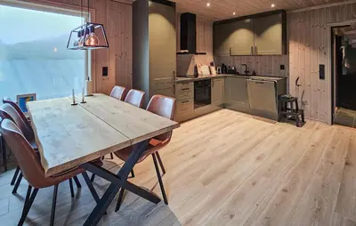 a large kitchen with a wooden table and chairs at Awesome Home In Rauland in Rauland