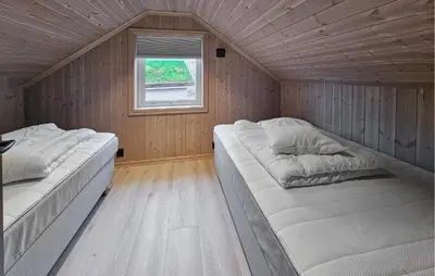 two beds in a small room with a window at Awesome Home In Rauland in Rauland