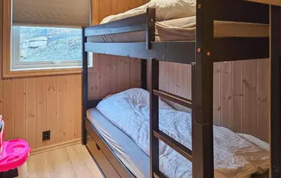 two bunk beds in a room with a window at Awesome Home In Rauland in Rauland