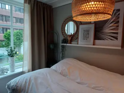 a bedroom with a bed and a chandelier and a window at Ytre Markveien 37 in Bergen