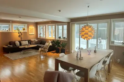 a living room with a table and a couch at Stor enebolig i Trondheim in Trondheim