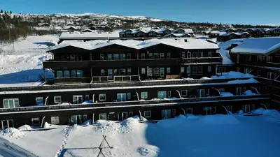 a building covered in snow with snow covered roofs at Ideal Family Retreat With 3 Bedrooms in Beitostøl