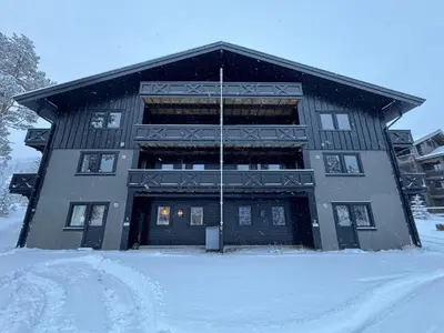 a building with snow on the ground in front of it at Spacious apartment near Hemsedal ski resort in Hemsedal