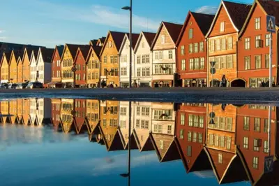 a row of houses with their reflections in the water at Flat in Bergen house with outstanding roof terrace in Bergen