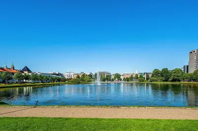 a large pond with a fountain in a city at Flat in Bergen house with outstanding roof terrace in Bergen