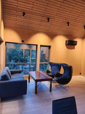 a living room with two chairs and a table at Nyoppført hytte med mulighet til å leie badestamp in Levanger