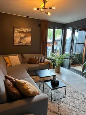 a living room with a couch and a table at Delikat og moderne rekkehus in Lillehammer