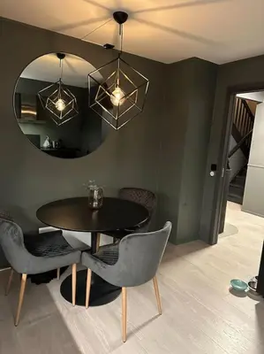 a dining room with a table and chairs and a mirror at Delikat og moderne rekkehus in Lillehammer