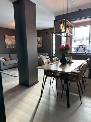a dining room with a table with flowers on it at Delikat og moderne rekkehus in Lillehammer