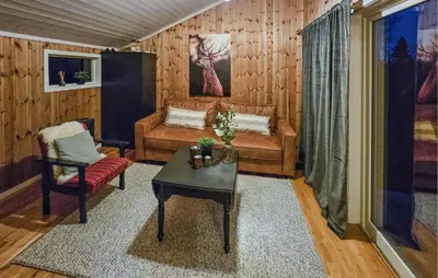 a living room with a couch and a table at 3 Bedroom Nice Home In Tuddal in Tuddal