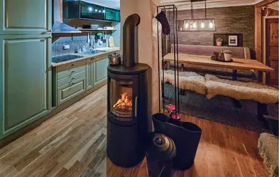 a kitchen with a wood stove in a room at 3 Bedroom Nice Home In Tuddal in Tuddal