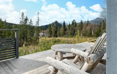 a wooden deck with a table and two chairs on it at 3 Bedroom Nice Home In Tuddal in Tuddal
