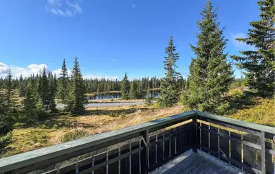 a balcony with a view of a field and trees at Stunning Home In Sjusjøen With Sauna in Sjusjøen
