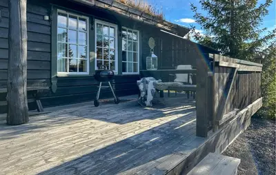 a back porch of a house with a grill at Stunning Home In Sjusjøen With Sauna in Sjusjøen
