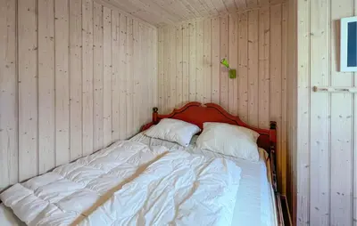 a bed in a corner of a room at Stunning Home In Sjusjøen With Sauna in Sjusjøen